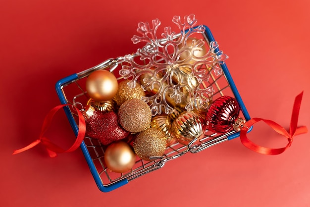 Basket of Christmas toys on a red background  balls stars and snowflake red and gold High qualit