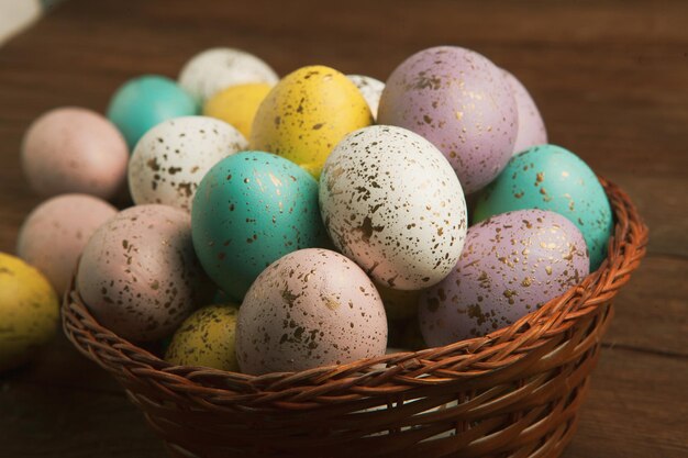 A basket of colorful easter eggs with gold dots and gold dots.