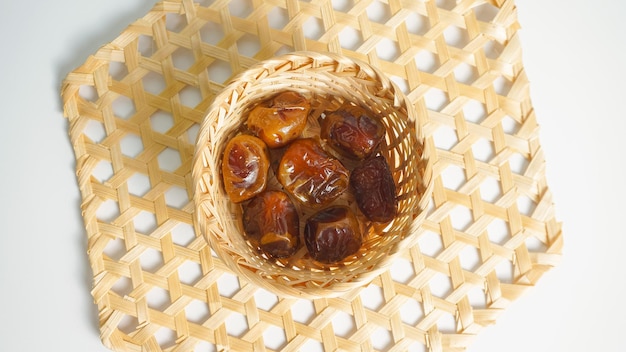 basket of delicious dried dates Kurma isolated on white board