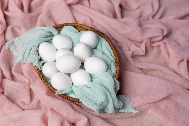 A basket of eggs on a pink cloth