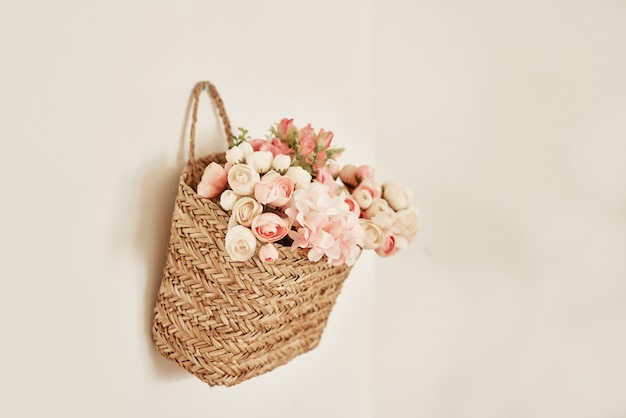 Basket of flowers on wall.