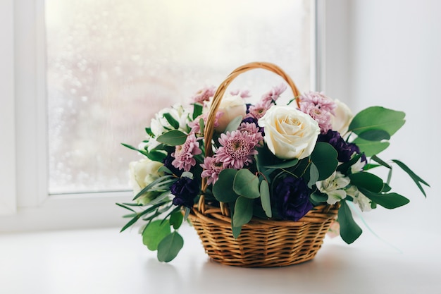 Basket of flowers on the window, vintage colors