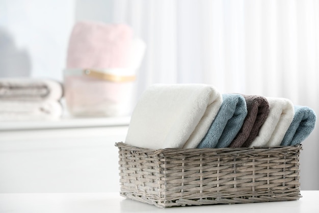 Basket of fresh towels on table Space for text