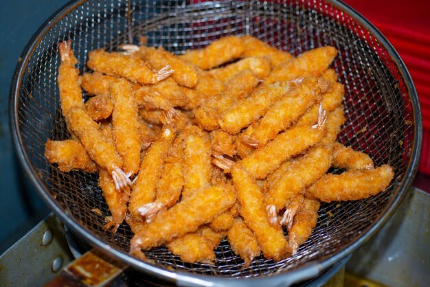 A basket of fried food with a fried egg on it