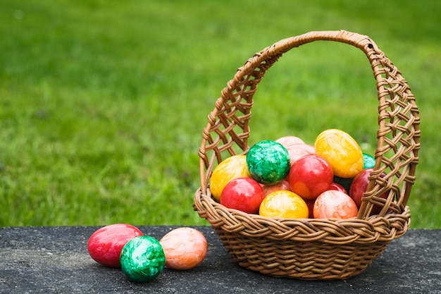 Basket full of Easter eggs on a stone slab