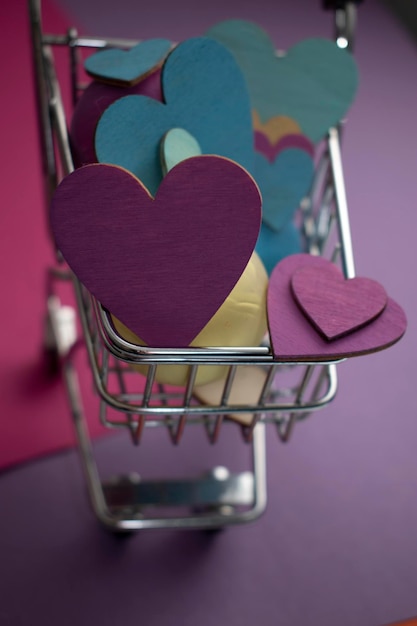 A basket full of hearts with a purple background.