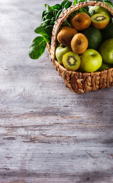 Basket of green fruit and vegetables.