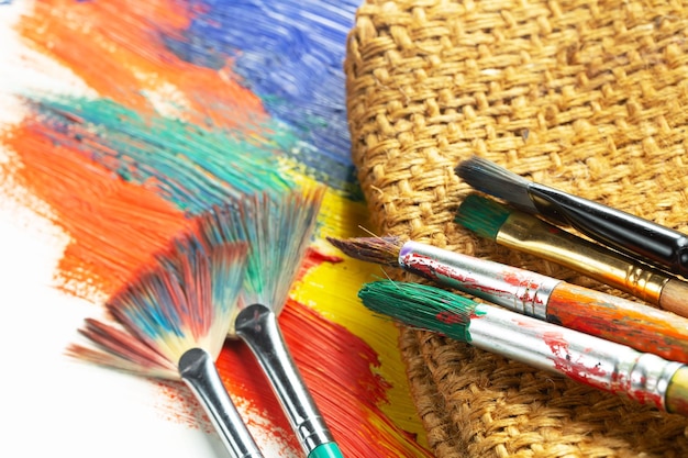 A basket of paint brushes with the word art on it