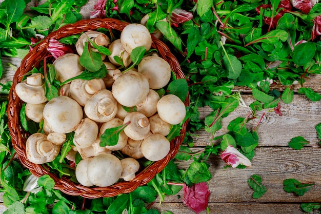 Basket salad with mushrooms, on rusty old background