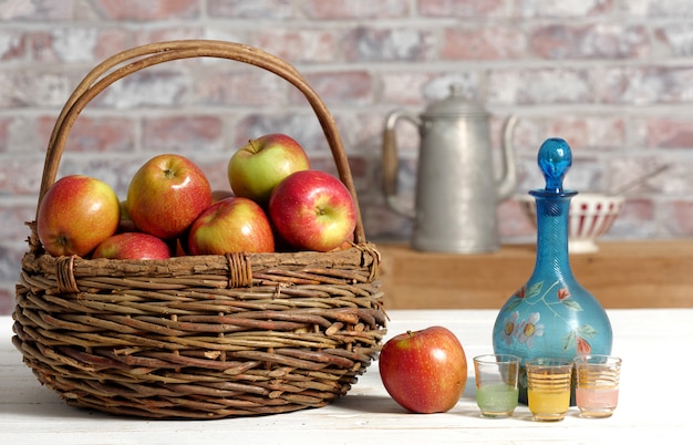 Basket with applesand carafe of calvados