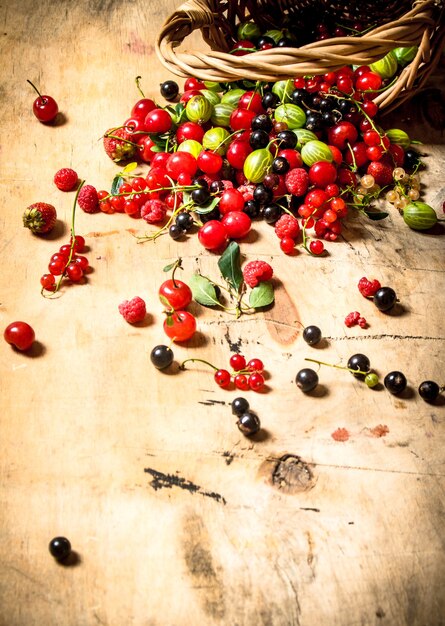 Basket with berries on a wooden table.