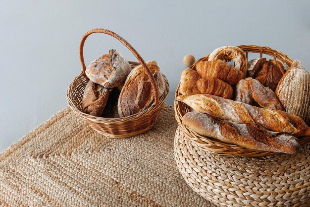 Basket with bread on a decorative burlap carpet Culinary baking background
