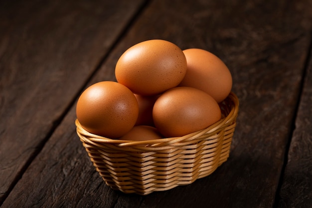 Basket with brown chicken eggs goes up the table