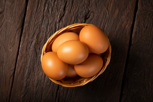 Basket with brown chicken eggs goes up the table