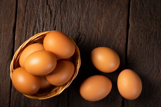 Basket with brown chicken eggs goes up the table