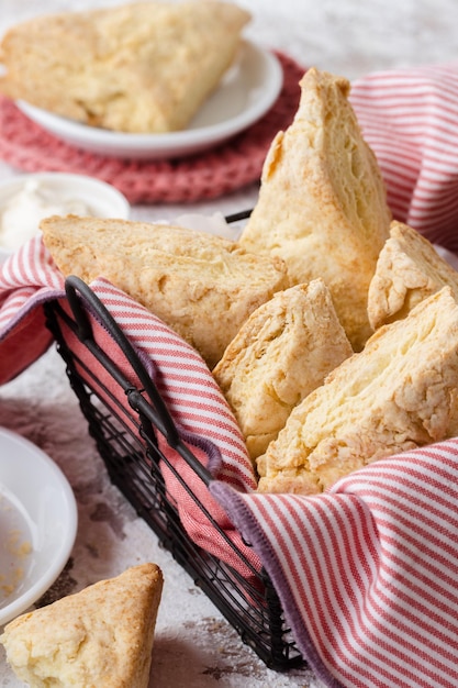 Basket with cheese scones Table set for afternoon tea with cheese scones