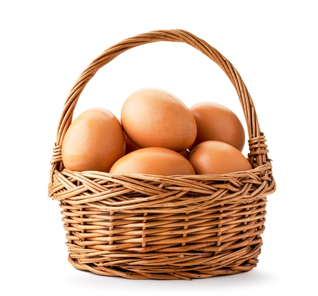 Basket with chicken eggs closeup on a white background