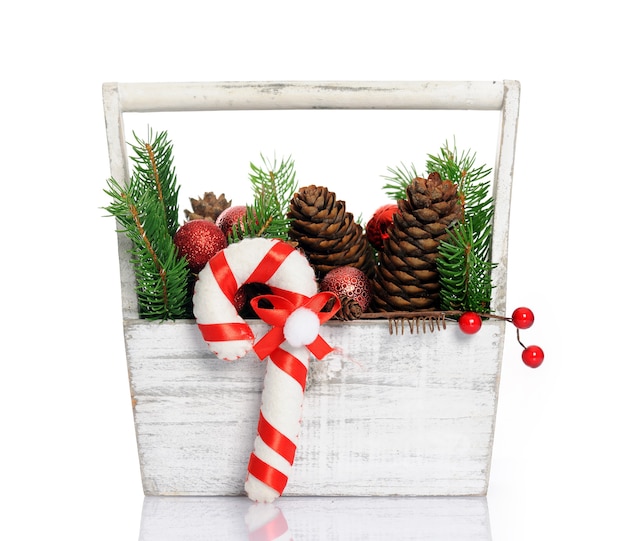 Basket with christmas decoration on white background