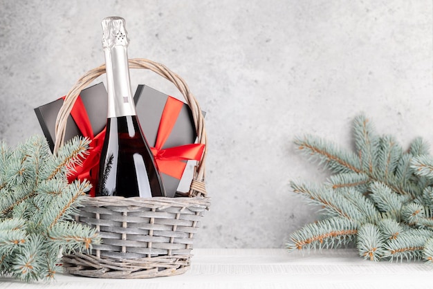 Photo basket with christmas gift boxes champagne