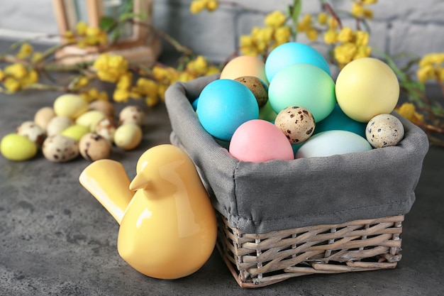 Basket with colorful Easter eggs on table