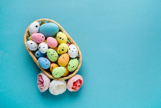 A basket with Easter eggs on a blue background Copy space