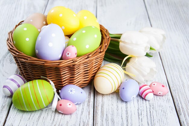 basket with easter eggs and tulips