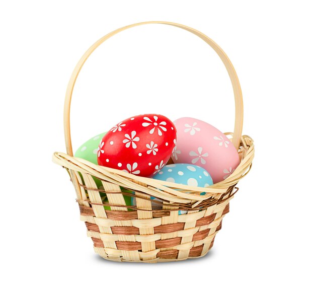 Basket with easter eggs on white isolated wall