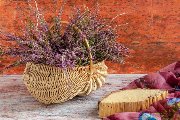 Basket with flowers on a red and white background lilac heather copy space
