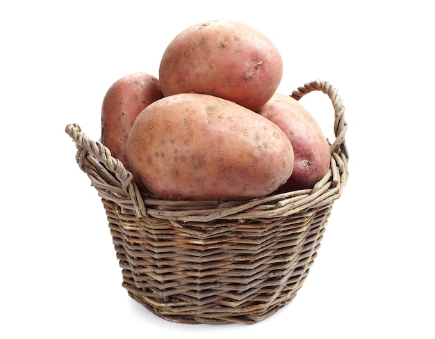 Basket with fresh potatoes on white background