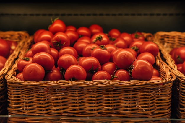 basket with fresh red tomatoes in grocery store Image with selective focus