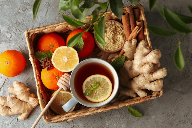 Basket with ginger, orange, cinnamon, lemon and tea