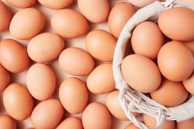 Basket with homemade eggs centered in the middle of the picture with more eggs in the background