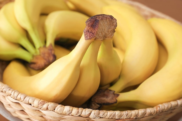 Basket with tasty ripe bananas closeup