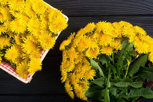 Basket with yellow dandelion flower nature background