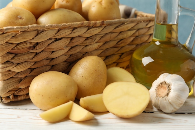 Basket with young potatoes on wooden surface