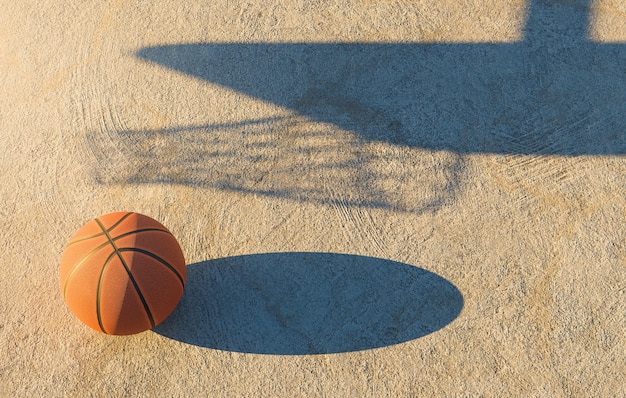 Basketball ball on concrete floor with the shadow of the goal next to it