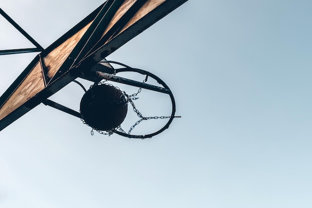 Basketball ball passing through the hoop outdoors against the backdrop of the sky Sports concept