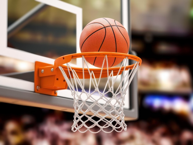 Basketball ball scoring the winning points on basketball net\
hoop on basketball arena