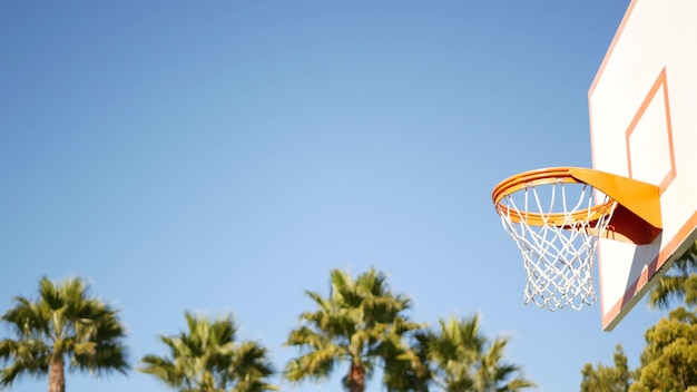 Баскетбольная площадка на открытом воздухе с оранжевой обручем и щитом для игры в баскетбол