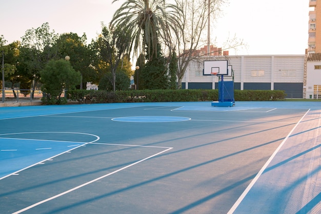 Basketball court without people at sunset