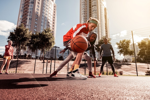 During the basketball match. Nice young people trying to get the ball while playing a game