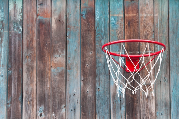 Basketball net on an old wooden wall.