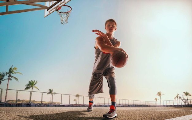 Basketball player in action on sunset