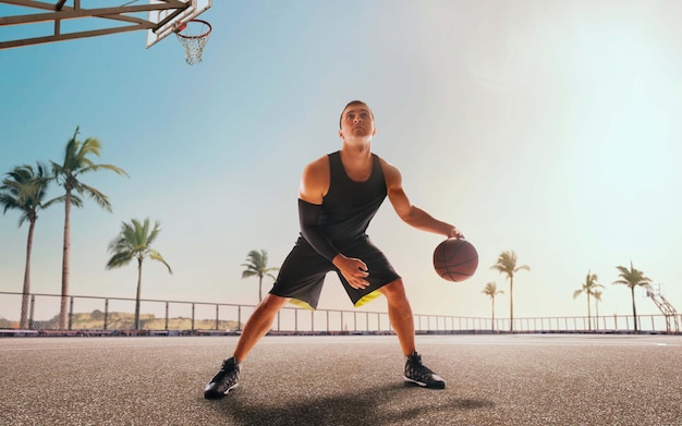 Basketball player in action on sunset