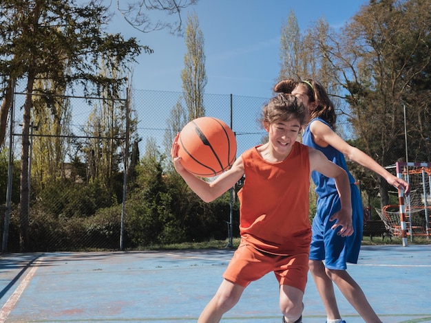 Basketball player dribbling another