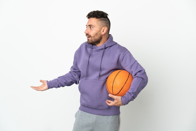 Basketball player man isolated on white background with surprise expression while looking side