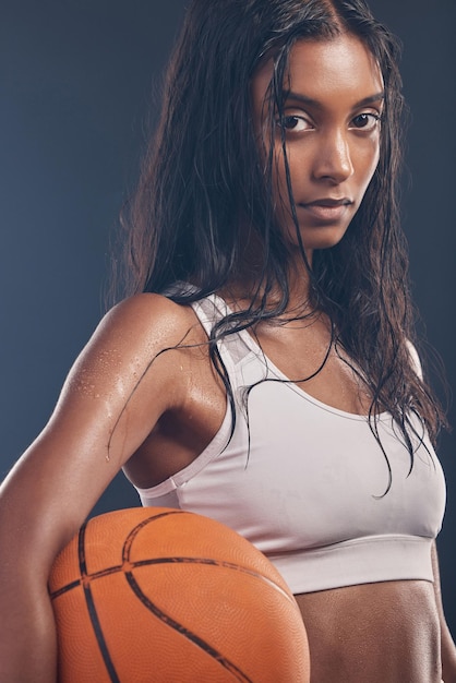 Basketball player portrait sports workout and woman for studio challenge practice game or fitness competition Performance training health exercise and athlete model isolated on dark background