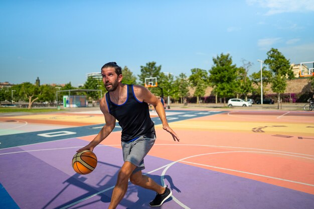 Basketball player runs on a basketball court with a ball