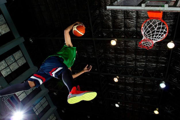 Photo basketball player slam dunk in the game.