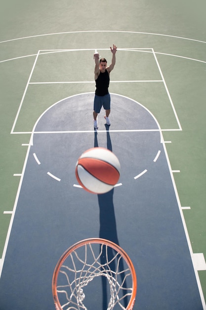 Basketball player top view Man playing basketball above hoop of man shooting basketball